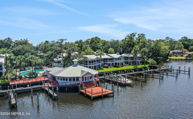 view of dock with a water view and a swimming pool