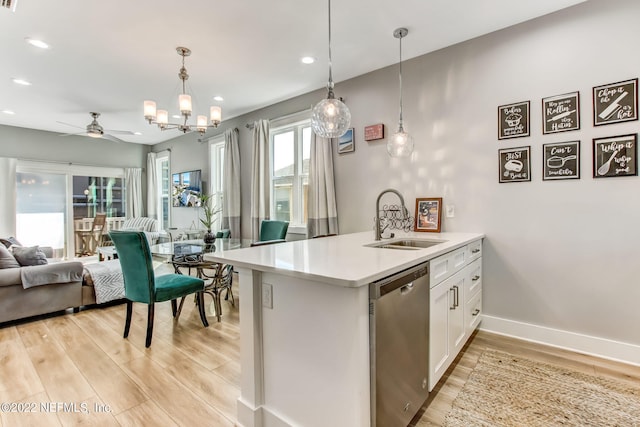 kitchen featuring dishwasher, pendant lighting, light hardwood / wood-style flooring, and sink