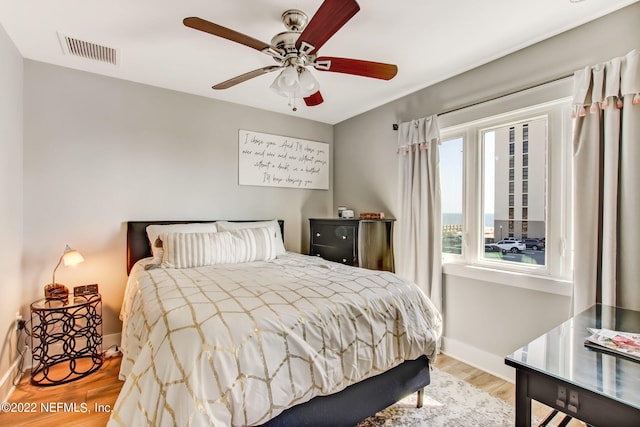 bedroom with ceiling fan and light hardwood / wood-style floors