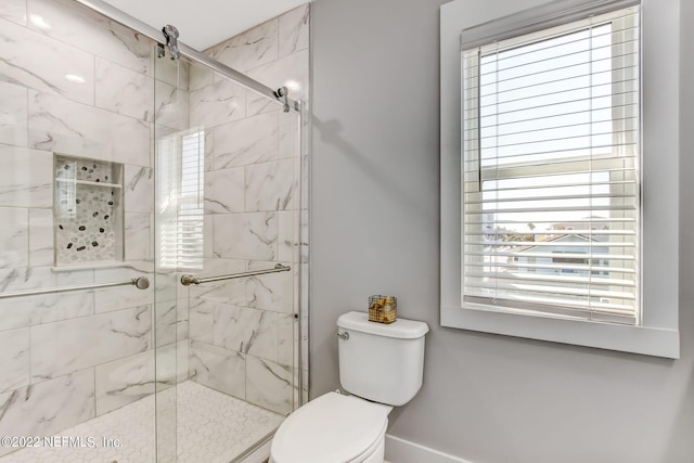 bathroom featuring toilet, a healthy amount of sunlight, and walk in shower