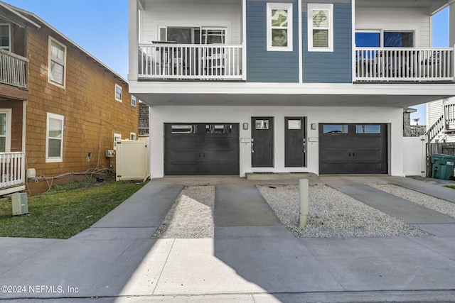 view of front of house with a garage and a balcony