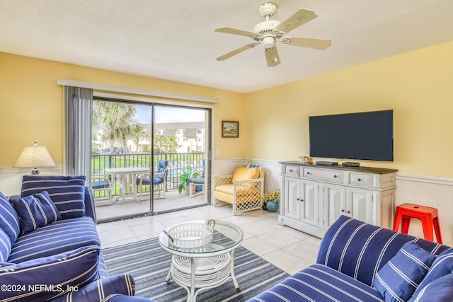 8550 A1A Unit 241, Saint Augustine, FL 32080 - living room featuring light tile patterned flooring, a ceiling fan, and wainscoting