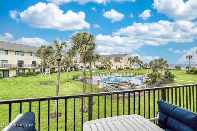 deck featuring a yard and a community pool