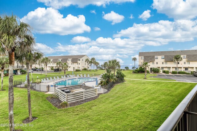 exterior space featuring a lawn and a pool