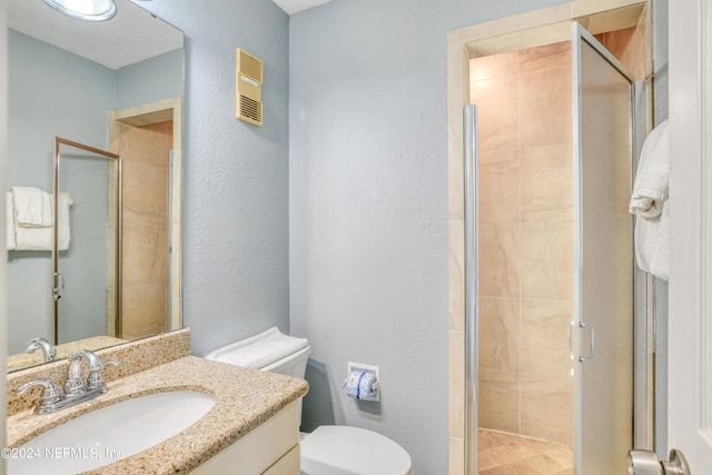 bathroom featuring an enclosed shower, toilet, and vanity