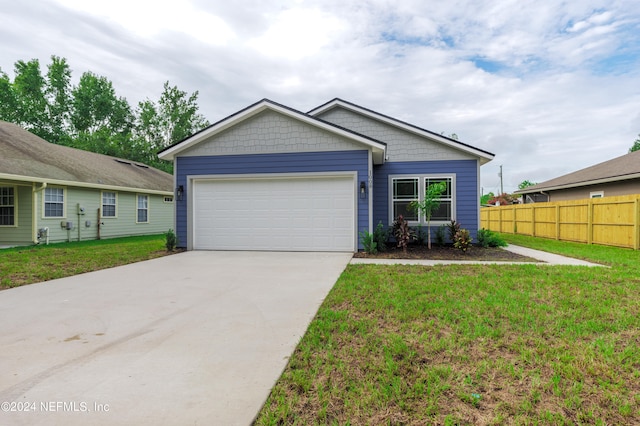 view of front of house with a garage and a front yard