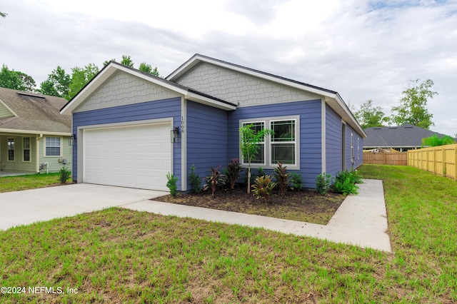 view of front of home featuring a front lawn and a garage