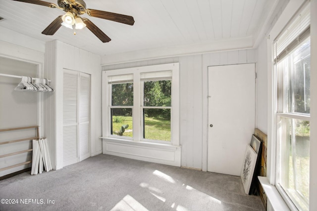 unfurnished sunroom with ceiling fan