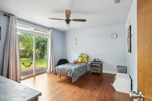 bedroom with hardwood / wood-style flooring, access to outside, and ceiling fan