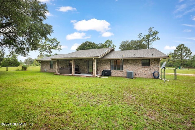 back of property featuring a yard, a patio, and central air condition unit