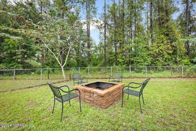 view of yard with a fire pit