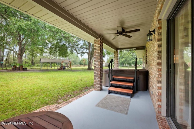 view of patio with a gazebo, a hot tub, and ceiling fan