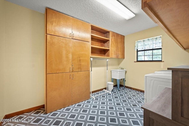 washroom featuring cabinets, a textured ceiling, and sink