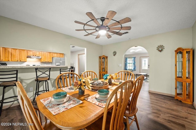 dining space featuring ceiling fan, dark hardwood / wood-style floors, and a textured ceiling