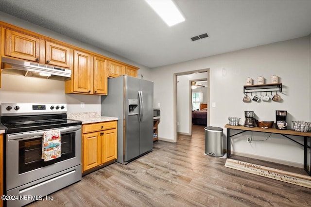 kitchen featuring stainless steel appliances and light hardwood / wood-style floors