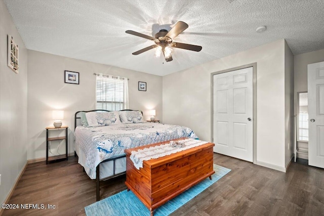 bedroom with ceiling fan, a textured ceiling, and dark hardwood / wood-style flooring