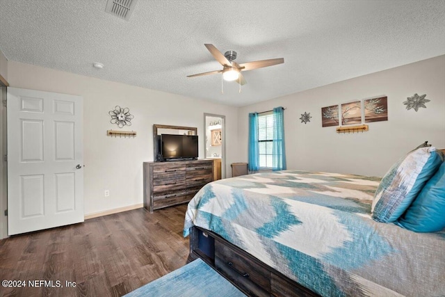 bedroom featuring ceiling fan, a textured ceiling, and dark wood-type flooring