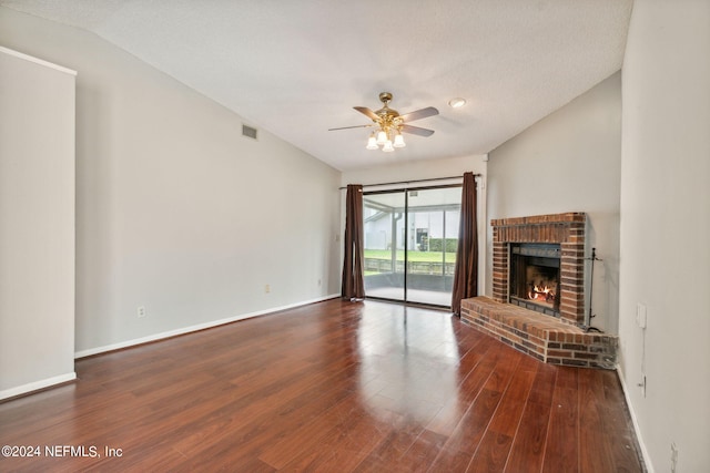9360 Craven Rd Unit 1307, Jacksonville, FL 32257 - unfurnished living room with visible vents, a brick fireplace, ceiling fan, wood finished floors, and lofted ceiling