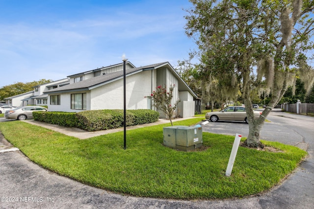 9360 Craven Rd Unit 1307, Jacksonville, FL 32257 - view of property exterior featuring stucco siding and a lawn