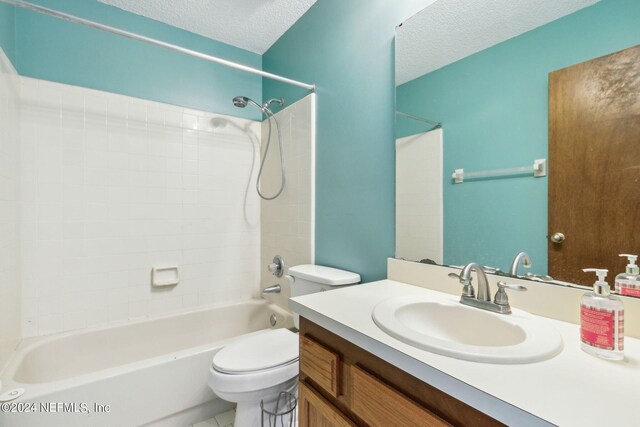 full bathroom with a textured ceiling, vanity, toilet, and shower / bathing tub combination