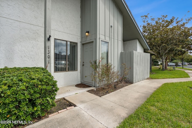 entrance to property with a yard