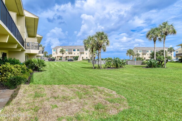 view of yard with a balcony