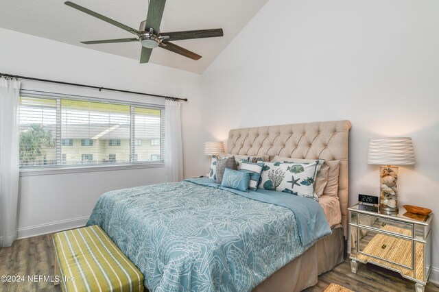 bedroom featuring vaulted ceiling, ceiling fan, and dark hardwood / wood-style flooring