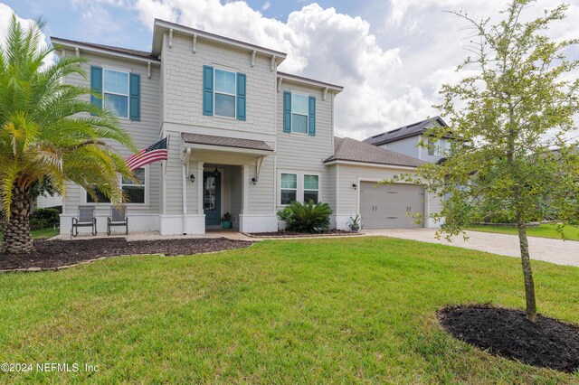 view of front facade featuring a front yard and a garage