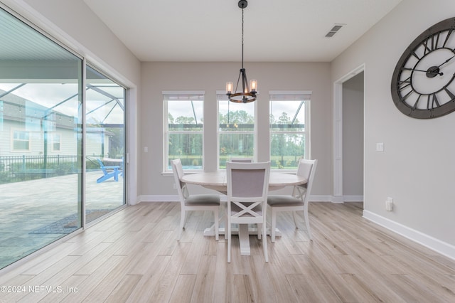 dining room featuring a notable chandelier and light hardwood / wood-style flooring