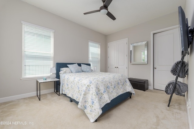 carpeted bedroom with ceiling fan