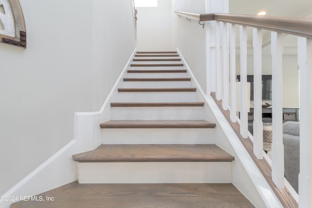 stairs with hardwood / wood-style flooring