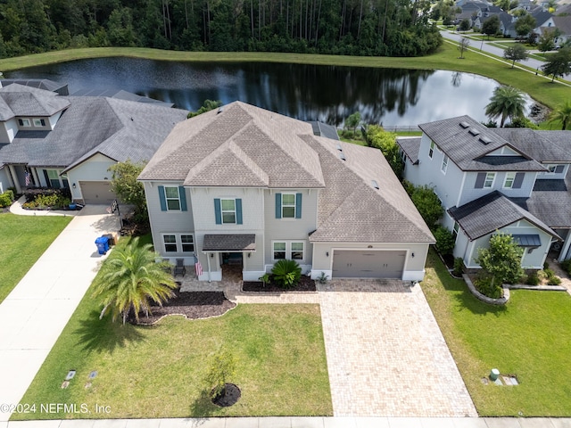 drone / aerial view featuring a residential view and a water view