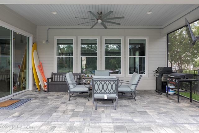 sunroom featuring ceiling fan