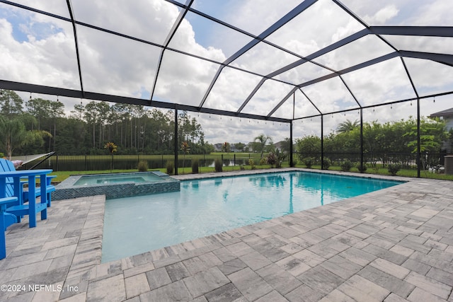 view of pool featuring an in ground hot tub, a patio area, and a lanai