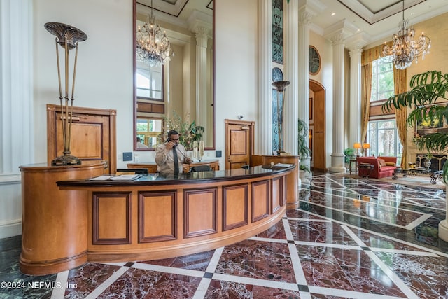 reception with ornate columns, arched walkways, and a notable chandelier