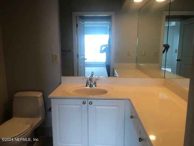 bathroom with toilet and vanity