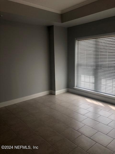 empty room with baseboards and ornamental molding
