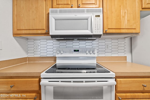 kitchen with white appliances and decorative backsplash