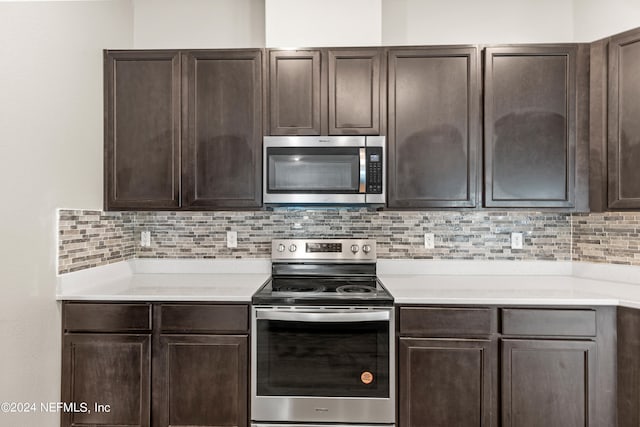 kitchen featuring dark brown cabinets, appliances with stainless steel finishes, and tasteful backsplash