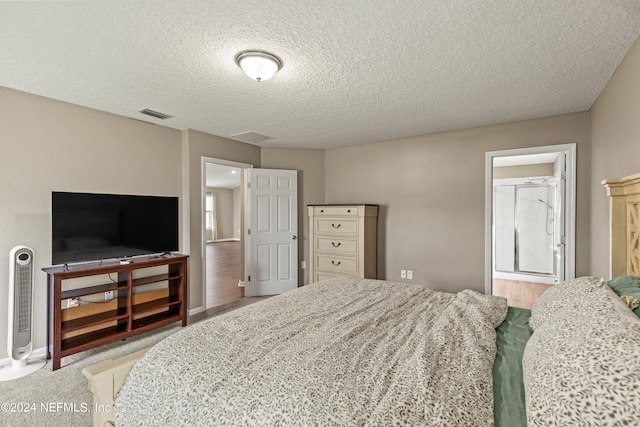 carpeted bedroom featuring a textured ceiling