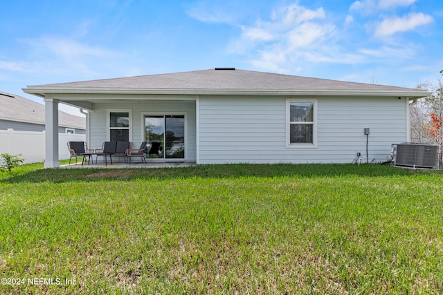 back of house featuring a patio, central air condition unit, and a yard