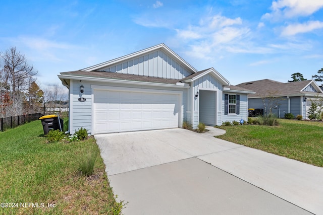 ranch-style house featuring a front yard and a garage