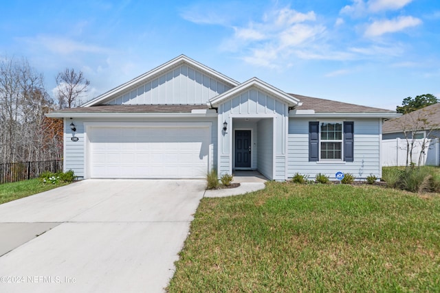 view of front of home featuring a garage and a front lawn