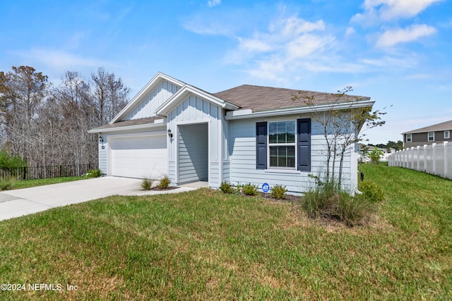 view of front of house with a front yard and a garage