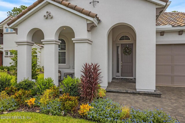 view of exterior entry with a garage