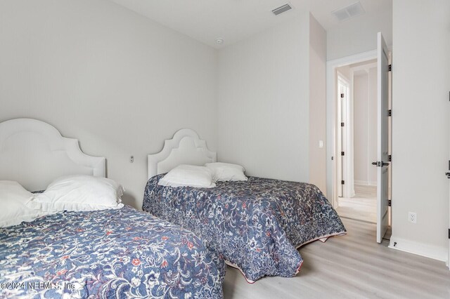 bedroom with light hardwood / wood-style floors