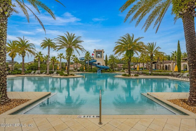 view of swimming pool with a water slide