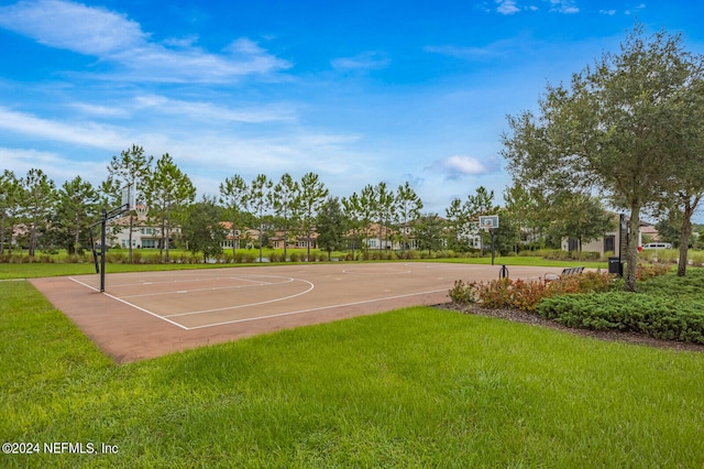 view of basketball court with a lawn