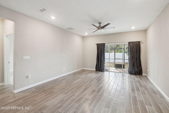 empty room with ceiling fan and light wood-type flooring