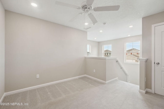 carpeted spare room with a textured ceiling